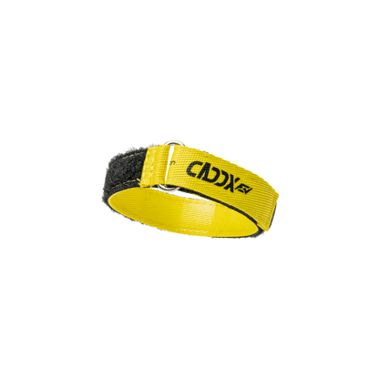 Yellow Caddx battery strap close-up, looped through metal buckle showing hook-and-loop fastening