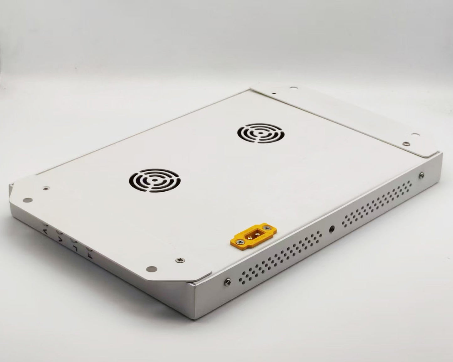 Rear metal housing of monitor with dual fan vents, side perforations, and yellow connector
