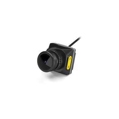 Walksnail Moonlight FPV camera three-quarter view with black lens barrel and yellow side plate