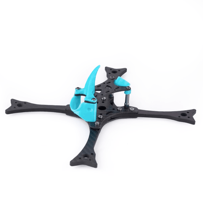 Assembled carbon FPV drone racing frame, angled side view showing stack standoffs and blue TPU camera mount