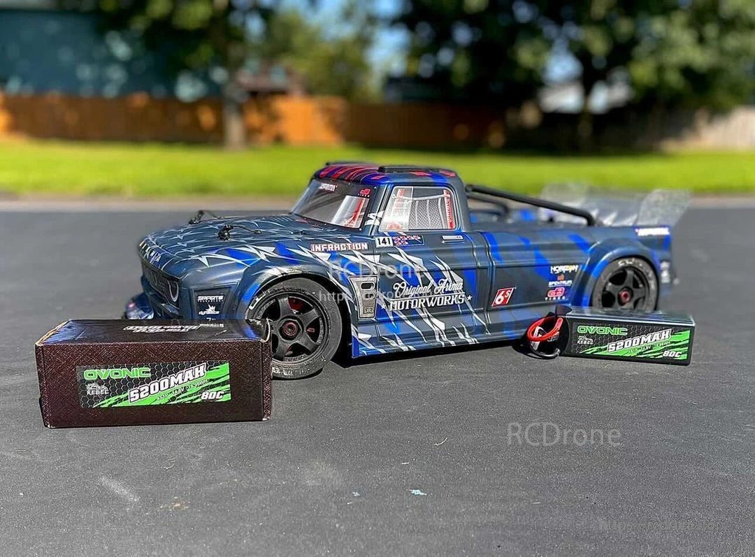 Ovonic Force 2-pack 3S 5200mAh 80C 11.1V hardcase LiPo batteries beside a 1/10 RC car