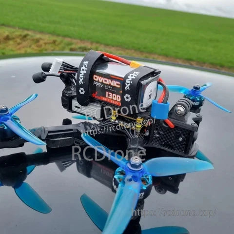 Ovonic Force 6S 1300mAh 130C 22.2V LiPo battery installed on a compact FPV quad with strap