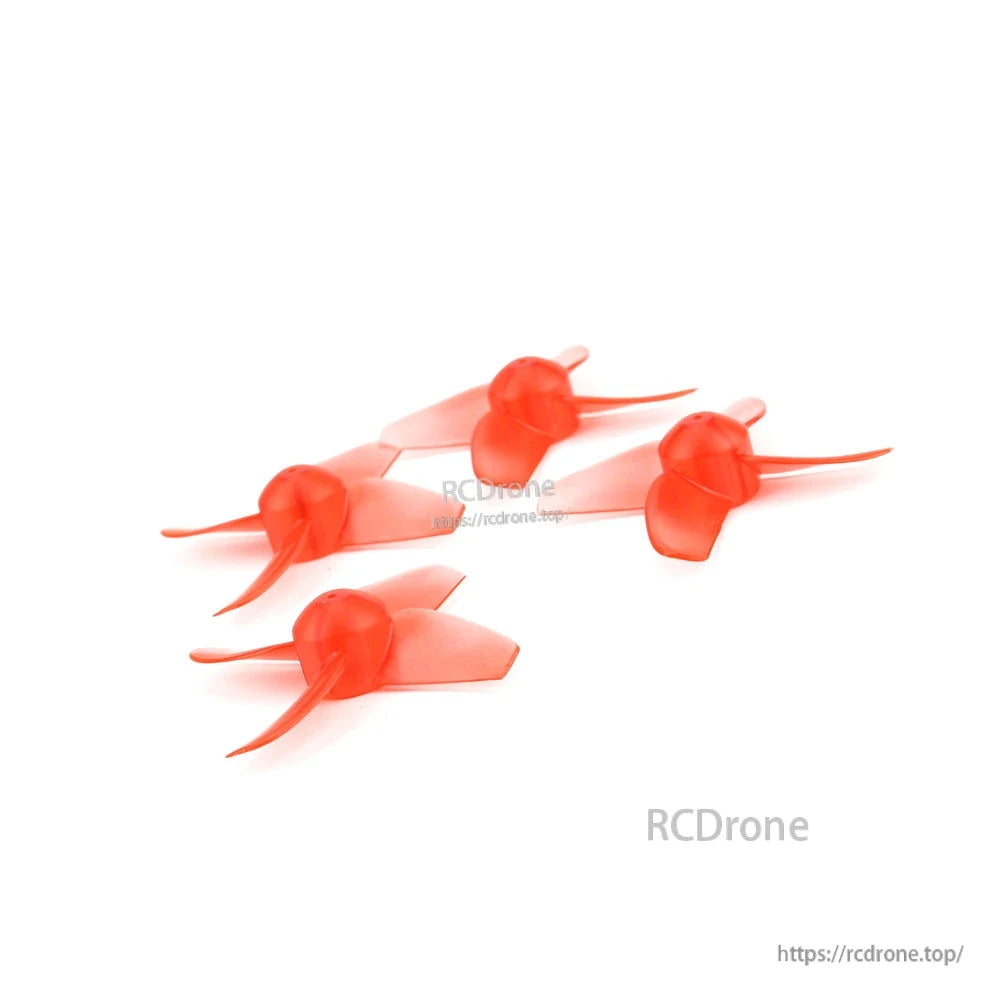Angled group view of four red quadcopter propellers, hubs and blades visible from above