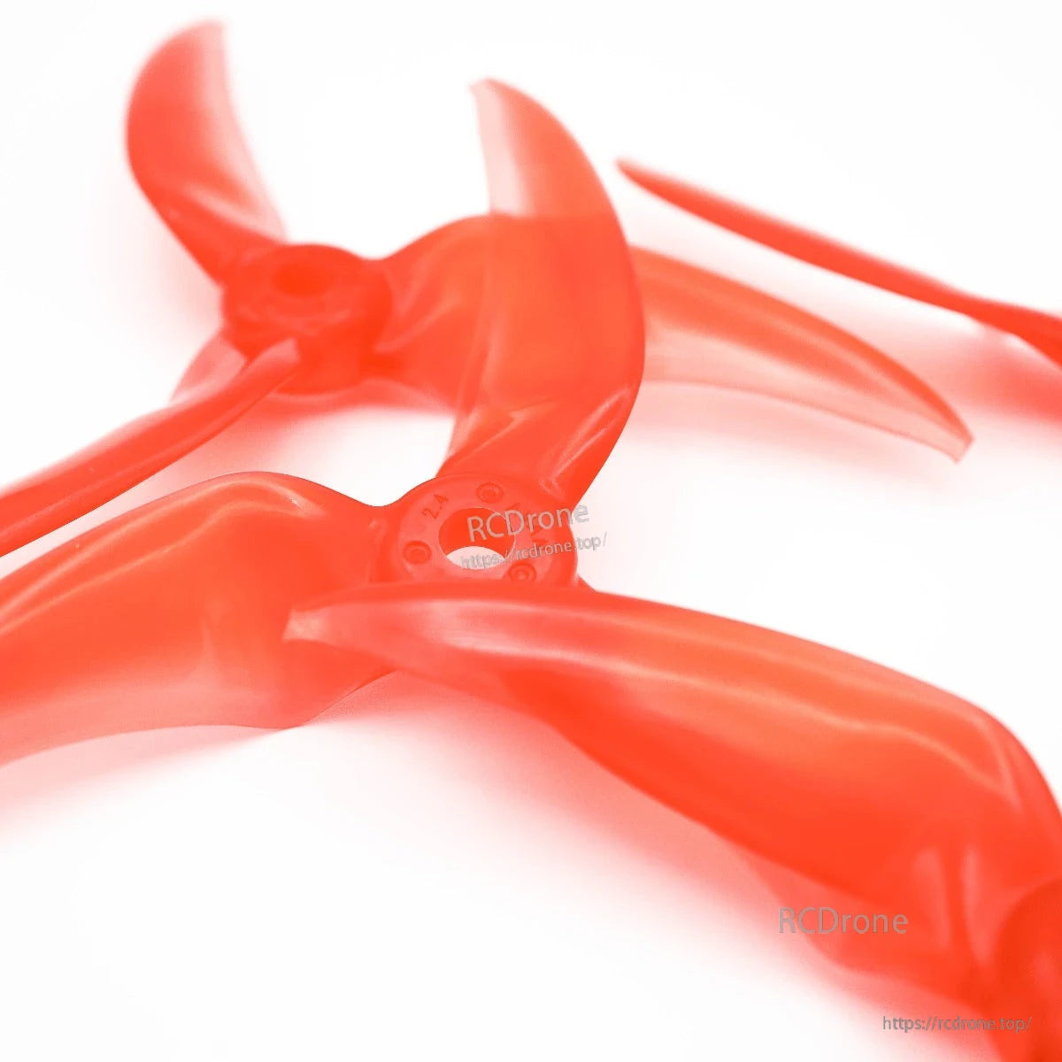 Angled view of overlapping translucent red tri-blade propellers highlighting hubs and blades