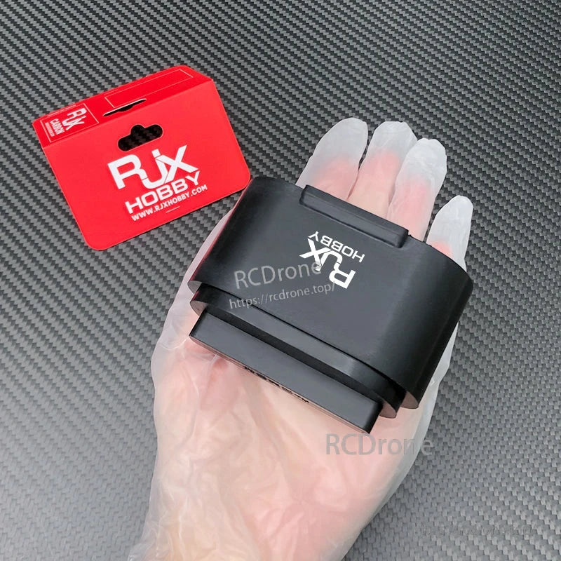 2 Sets RJX Rubber Protective Cover, Black RJX Hobby rubber protective cover held in hand, with red RJX packaging on a carbon-fiber background