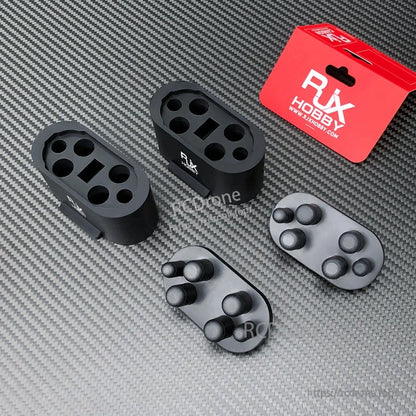 2 Sets RJX Rubber Protective Cover, Two RJX Hobby rubber protective covers with matching plug inserts, black and gray, on a carbon-fiber surface