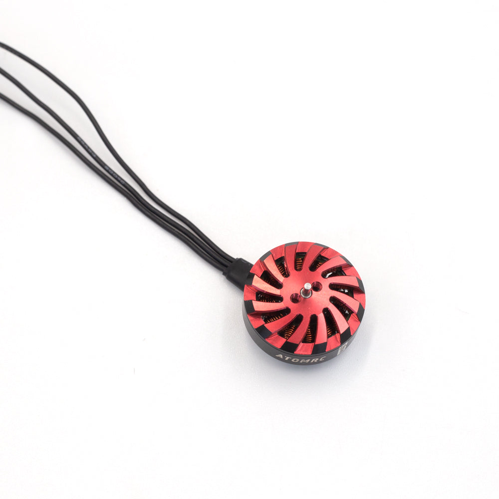 Top-down view of red vented motor cap with center shaft and three black lead wires