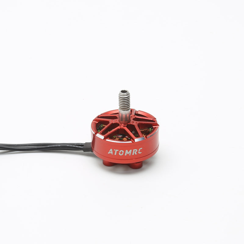 ATOMRC 2306 brushless motor in red aluminum housing with threaded shaft and lead wires, studio view