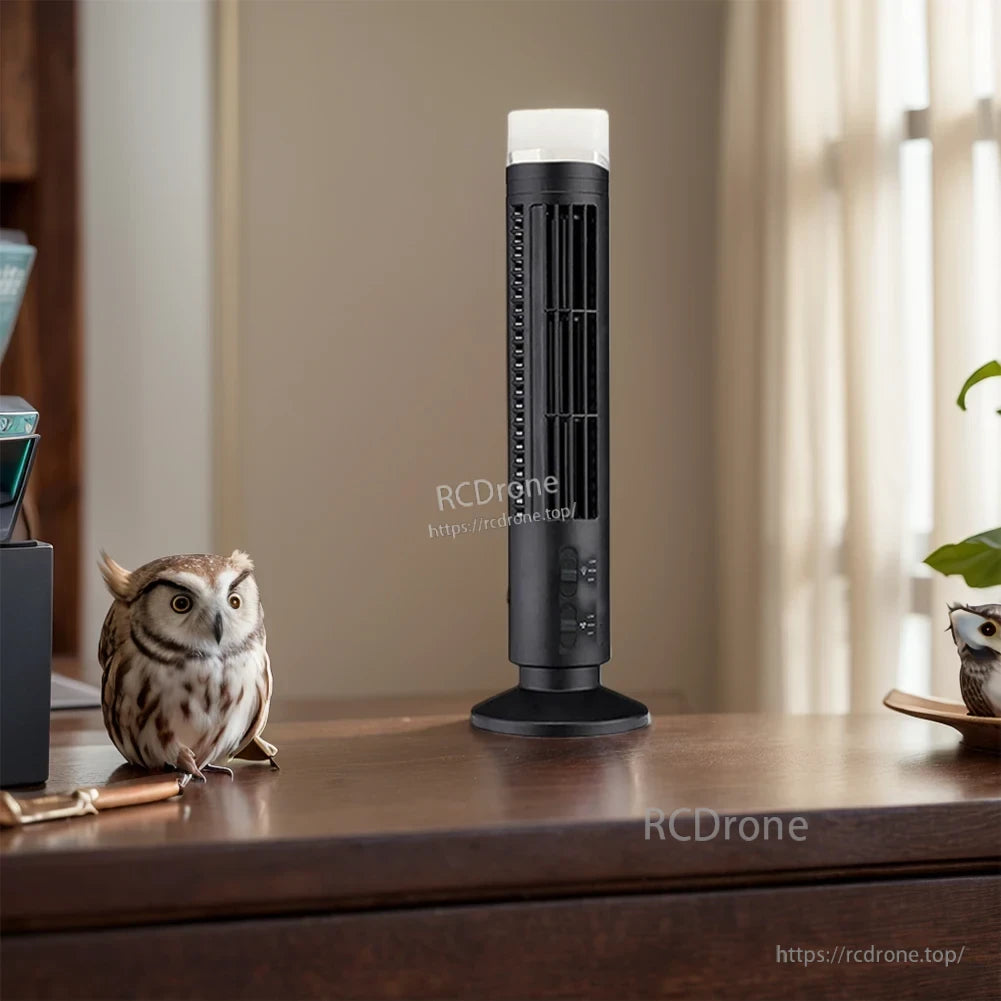 Black LED tower fan on a desk, compact stand fan for office desktop airflow