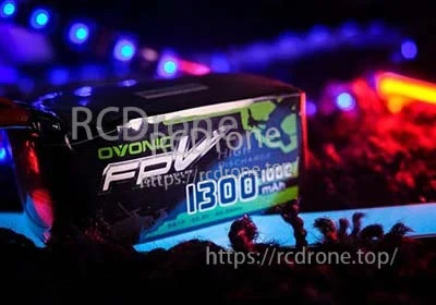 Ovonic FPV 1300mAh 100C LiPo battery pack in low-light lifestyle shot highlighting label