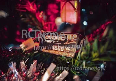Close-up of Ovonic FPV 1600mAh 4S 14.8V 120C LiPo battery on grass with wiring visible