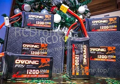 Multiple Ovonic FPV 1200mAh 6S LiPo packs with XT60 connectors arranged with storage boxes