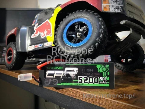 Ovonic 2S 5200mAh 50C 7.4V hardcase LiPo battery with T plug next to 1/10 RC truck