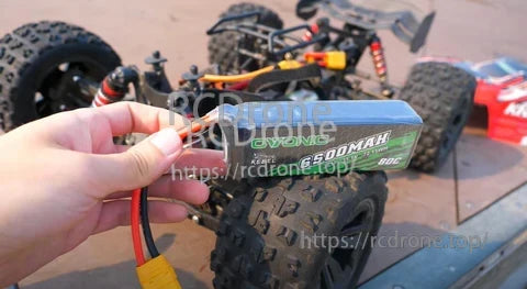 Ovonic Rebel 3S 11.1V 6500mAh 80C softcase LiPo battery with XT90 plug held next to RC car