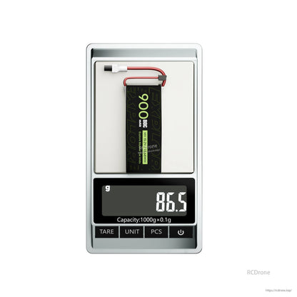 Flywoo Explorer 900mAh 4S LiHV LiPo battery on digital scale, 86.5g, with main lead and balance plug