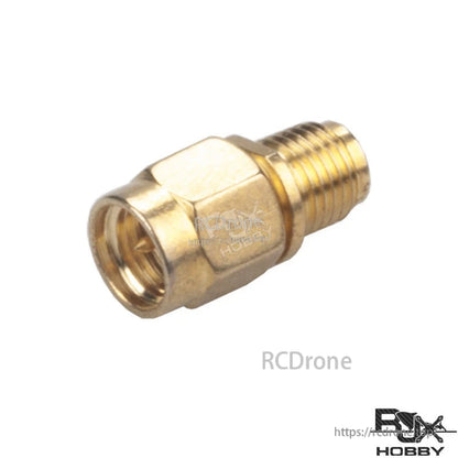 Gold RF coaxial adapter with SMA male plug and RP-SMA female connector, hex body and threaded end