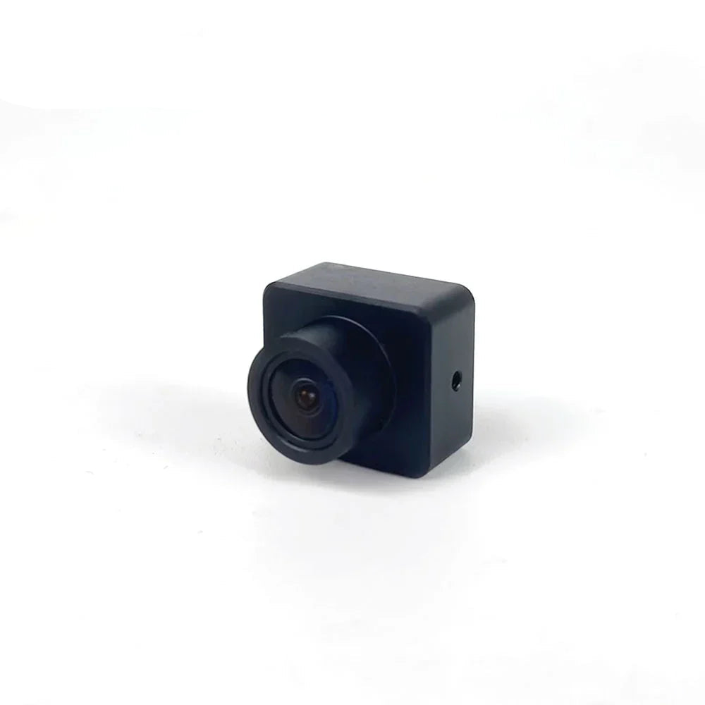 Compact FPV drone camera front-left view showing square housing and lens barrel