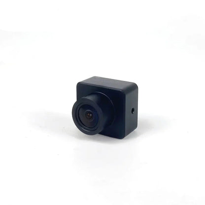 Compact FPV drone camera front-left view showing square housing and lens barrel