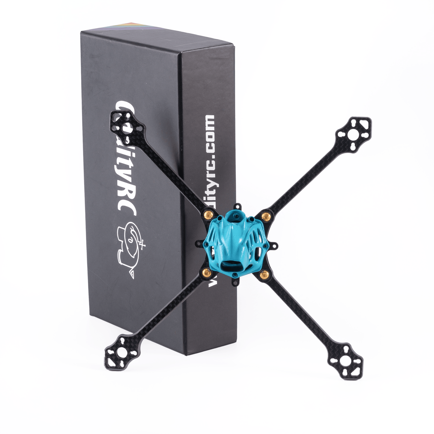 Top-down view of carbon fiber toothpick quad frame with blue canopy, OddityRC box standing behind