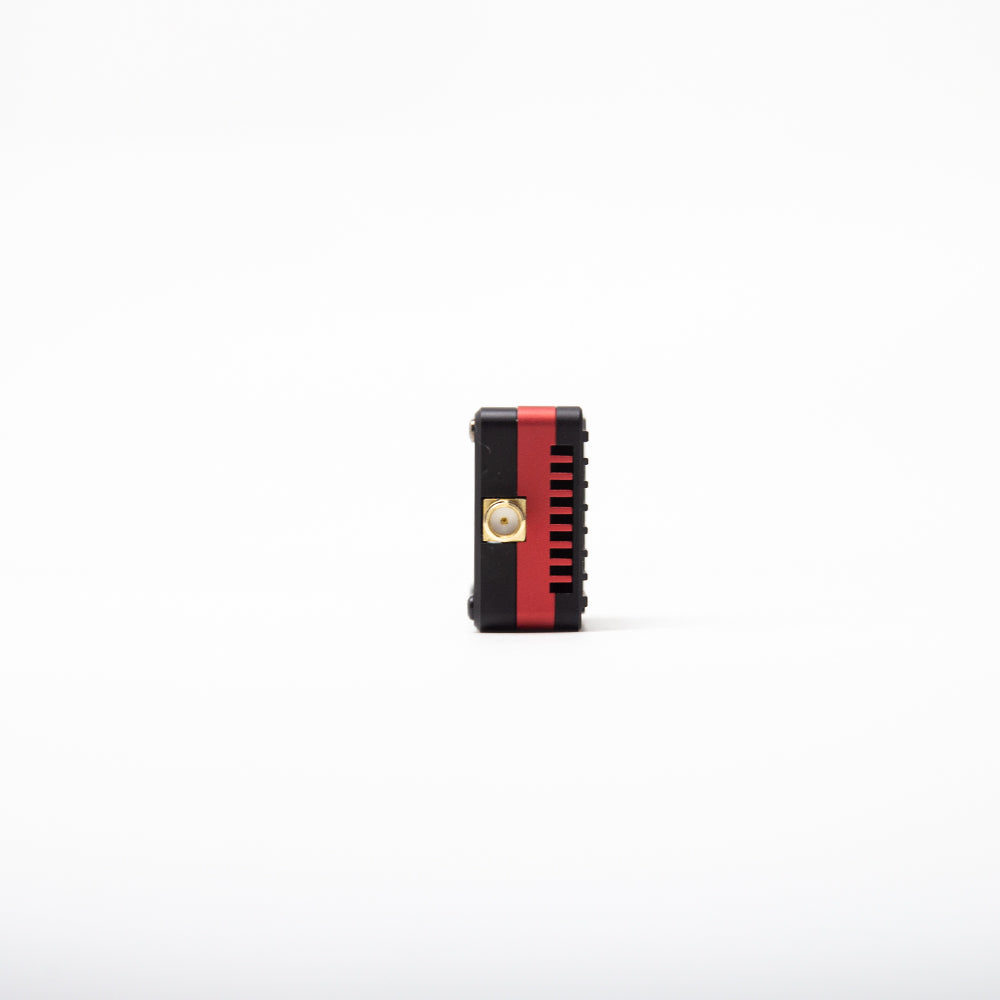 Side profile of VT7550 CNC video transmitter with SMA antenna connector and red heat-sink stripe