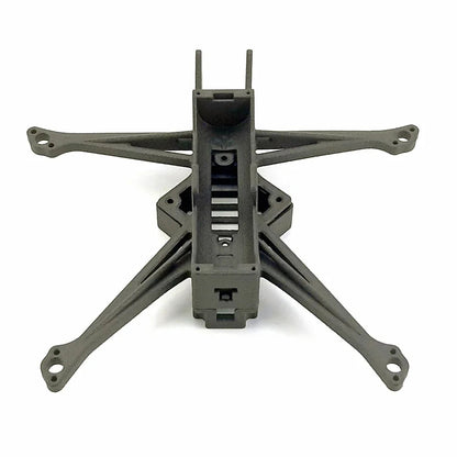 Front view of FPV drone frame with long arms and center spine opening for electronics stack