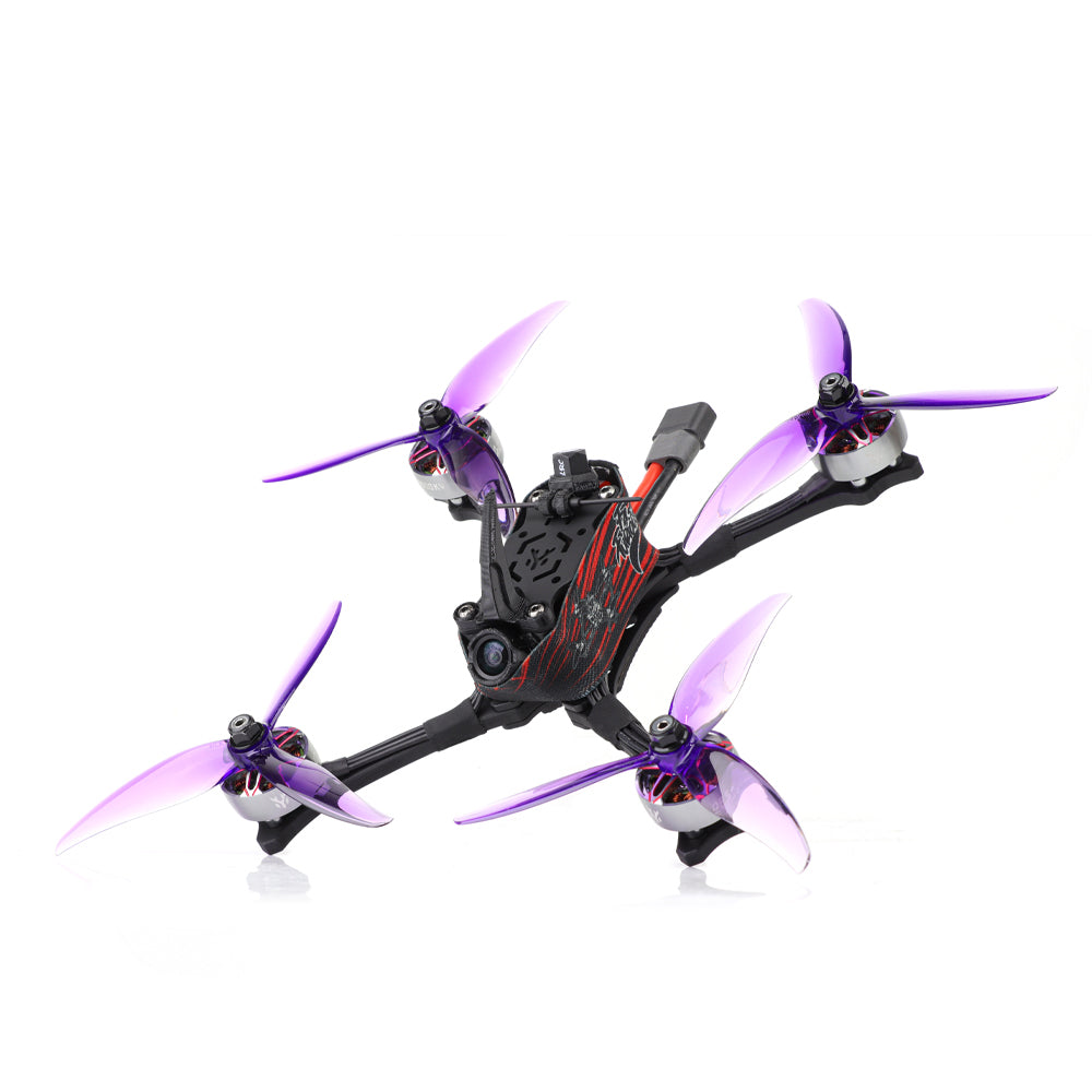 Top angled view showing HGLRC Wind5 Lite V2 quad frame, battery lead connector, and purple propellers