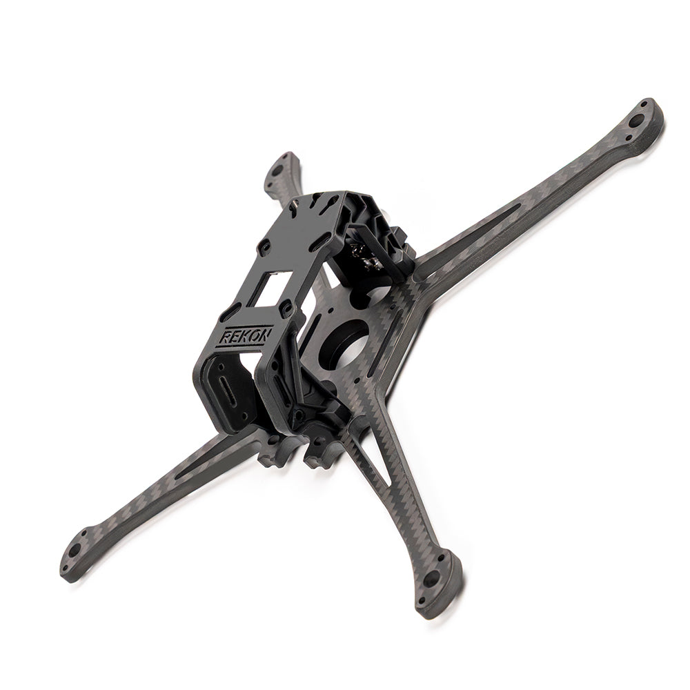 Angled top view of carbon fiber drone frame showing Rekon camera cage and arm cutouts