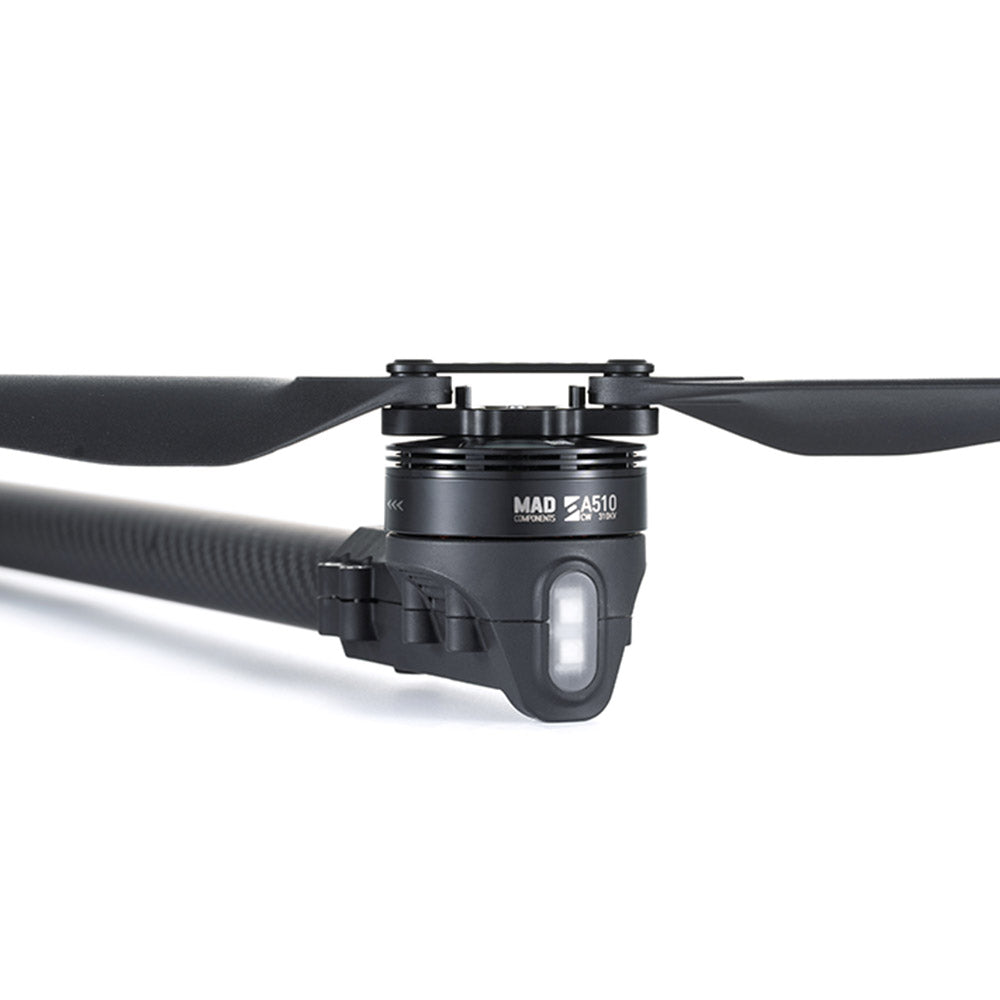 Close-up of MAD StableCore A510 drone arm with carbon-fiber tube, motor mount, and propeller