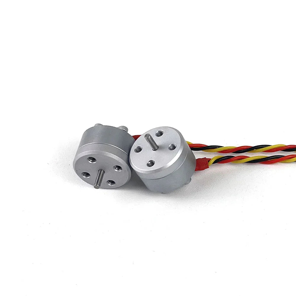 Pair of 1104 micro brushless motors shown side by side, front face with shaft and mounting holes
