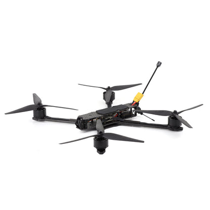 10-inch long-range FPV quadcopter side angle showing carbon arms, propellers, and XT60 battery lead