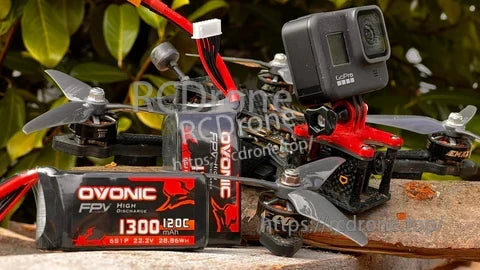 Ovonic 6S 1300mAh 22.2V LiPo pack strapped to an FPV drone, soft-case battery for racing builds