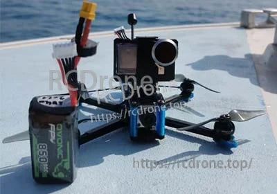 Ovonic 850mAh 4S LiPo battery next to an FPV quad and action camera, with XT30 plug visible