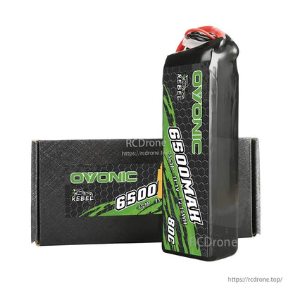 Standing battery in front of Ovonic Rebel box, showing softcase thickness and top wire entry