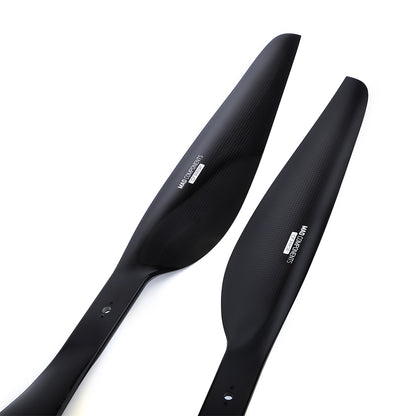 Pair of glossy black carbon fiber drone propeller blades with mounting holes and printed logo