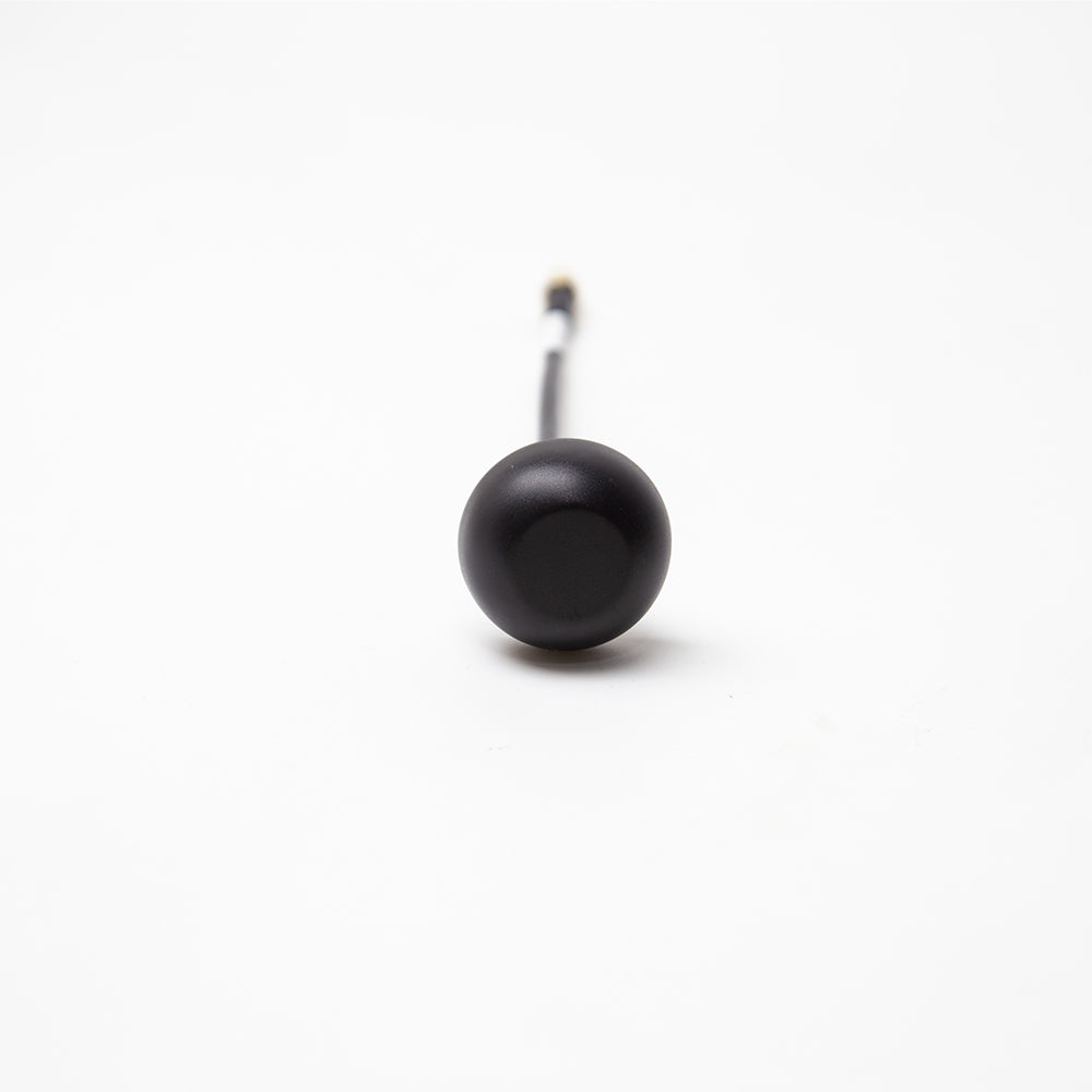 Front view of black mushroom antenna dome on coax lead, centered on white background