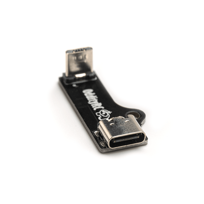 OddityRC USB Adapter board with USB-C port and Micro USB plug, angled close-up on white