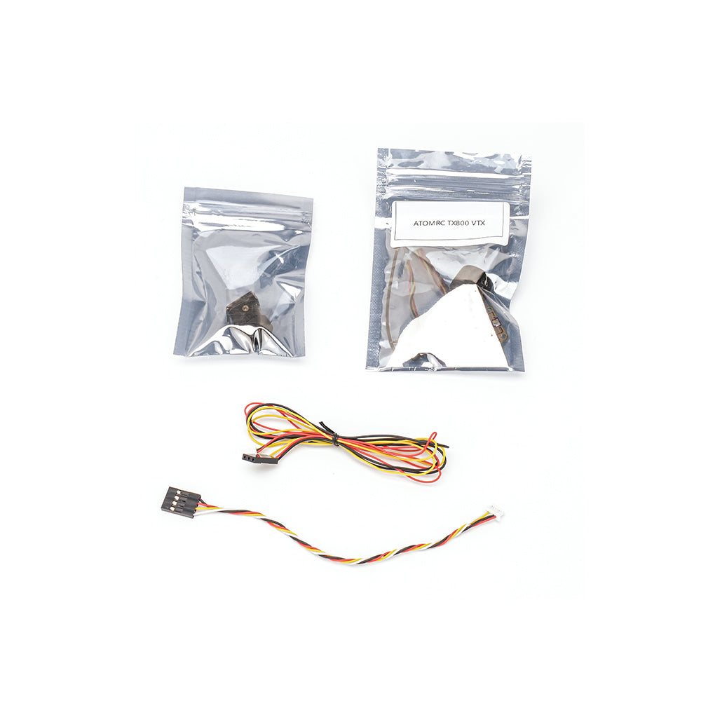 ATOMRC TX800 VTX parts in anti-static bags with two cable harnesses laid out on white background