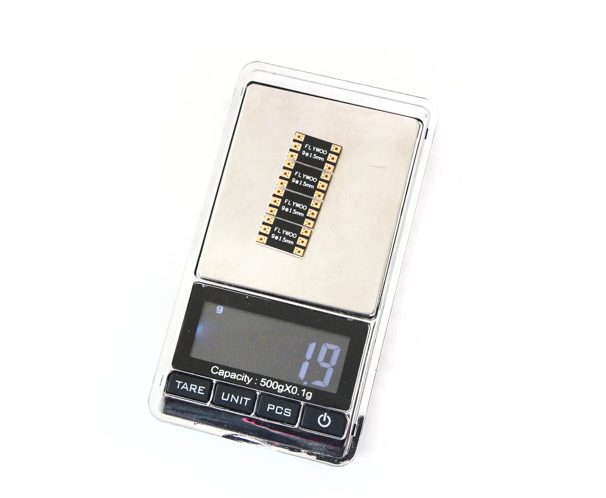 FLYWOO FPV drone frame arm board on a digital scale showing 1.9 g weight, with labeled solder pads