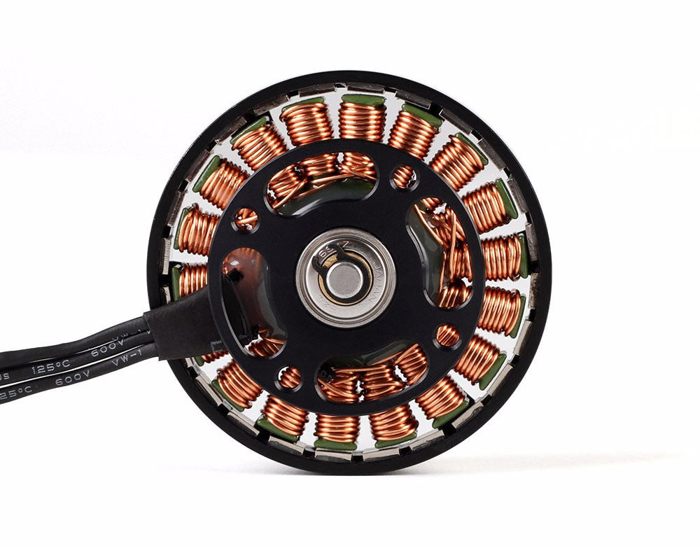 Close-up of a T-Motor brushless outrunner motor showing copper stator windings and power leads