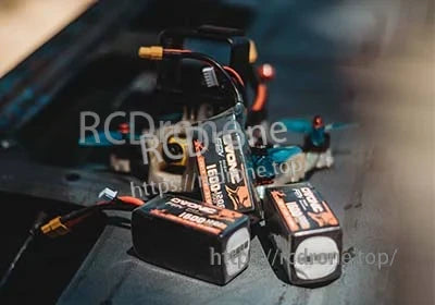 Four Ovonic 120C 6S 1600mAh 22.2V LiPo batteries with XT60 connectors on a workbench