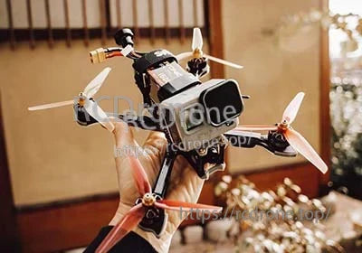 FPV quadcopter held in hand with an Ovonic 6S 1600mAh LiPo battery mounted on top plate