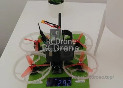 Micro FPV quad on a scale with an Ovonic 650mAh 3S LiPo installed, weight reading visible