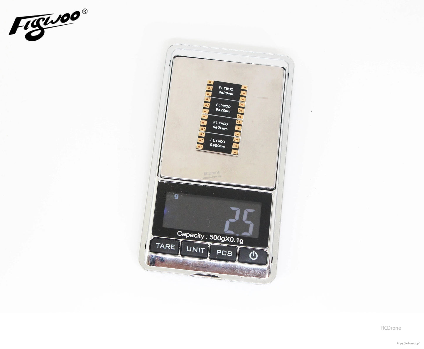 FLYWOO frame arm board set placed on a digital scale, showing a 25g reading for the small PCB strips