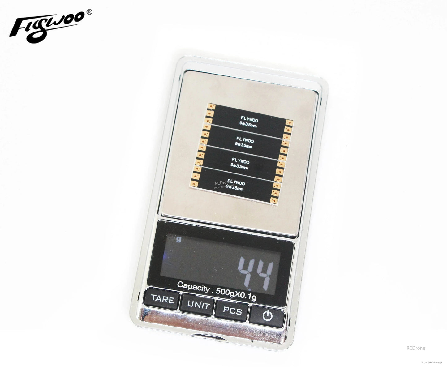 Flywoo frame arm board set on a digital gram scale, displaying an approximate weight of 4.4 g