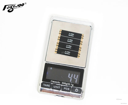 Flywoo frame arm board set on a digital gram scale, displaying an approximate weight of 4.4 g