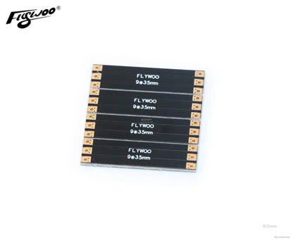 Four FLYWOO 9×35mm frame arm boards with solder pads at both ends for FPV drone wiring