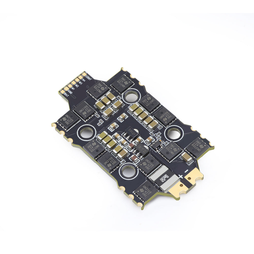 Flight controller underside at angle showing solder pads and components