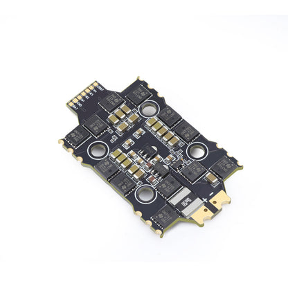 Flight controller underside at angle showing solder pads and components