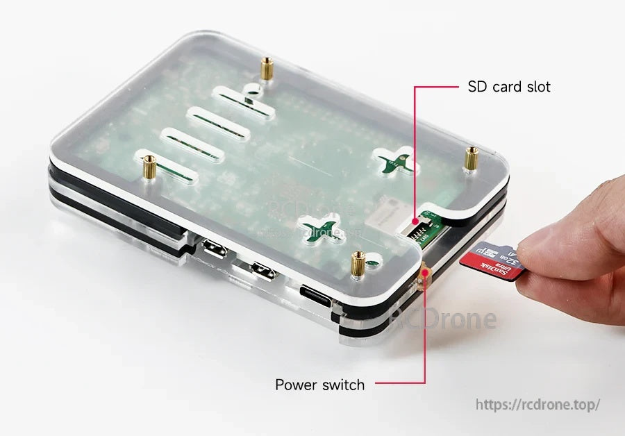 Bottom view highlighting accessible SD card slot and integrated power switch on the acrylic case.