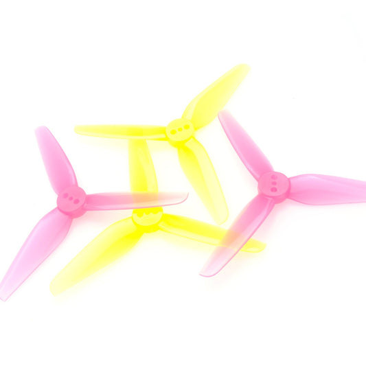 HQProp T3X1.8X3 3in tri-blade propellers in neon yellow and pink, stacked on white background